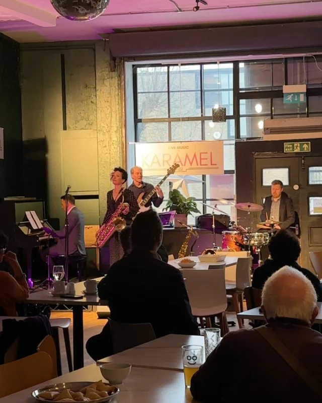 Women in Jazz Media Presents – “Women in Jazz Photography: Her Frame. Her Sound.” at Karamel N22

Private View – Sunday, April 13th

The vibrant space at Karamel N22 came alive with music, photography, and a shared sense of celebration as Women in Jazz Media, in partnership with Collage Arts, launched their latest exhibition:

“Women in Jazz Photography: Her Frame. Her Sound.”

Sunday’s private view at Karamel N22 marked the powerful opening of “Her Frame. Her Sound.” — a visually striking and soul-stirring exhibition curated by Women in Jazz Media. The room was filled with warmth, conversation, and creativity as guests gathered to celebrate the work of incredible women photographers capturing the world of jazz through their unique lens.

The exhibition brings together the work of six extraordinary women photographers from around the world — Val Wilmer, Monika S. Jakubowska, Vuyo Giba, Tatiana Gorilovsky, Enid Farber, and Kasia Ociepa — each offering a personal and powerful visual narrative. Their images don’t just document; they celebrate, capturing the spirit, emotion, and freedom at the heart of jazz.

The atmosphere at Karamel was buzzing with admiration, inspiration, and community. Attendees mingled with the photographers who were able to make it, and also the jazz lovers, while enjoying the venue’s signature vegan bites and laid-back vibe. It was an evening that embodied everything the exhibition stands for: representation, creativity, and the celebration of women in music and media.

The atmosphere on the night was electric, enhanced by a live performance from the phenomenal Hannah Horton and guest musicians, whose soulful set added an extra layer of magic and meaning to the evening.

There truly has never been an exhibition like this — and its impact is undeniable.
A heartfelt congratulations to Women in Jazz Media for curating such a powerful, international showcase, and to Karamel for providing the perfect home for it.

#WomenInJazzMedia #HerFrameHerSound #WomenInJazz #JazzPhotography #KaramelN22 #ArtExhibition #NorthLondonEvents #JazzThroughHerLens